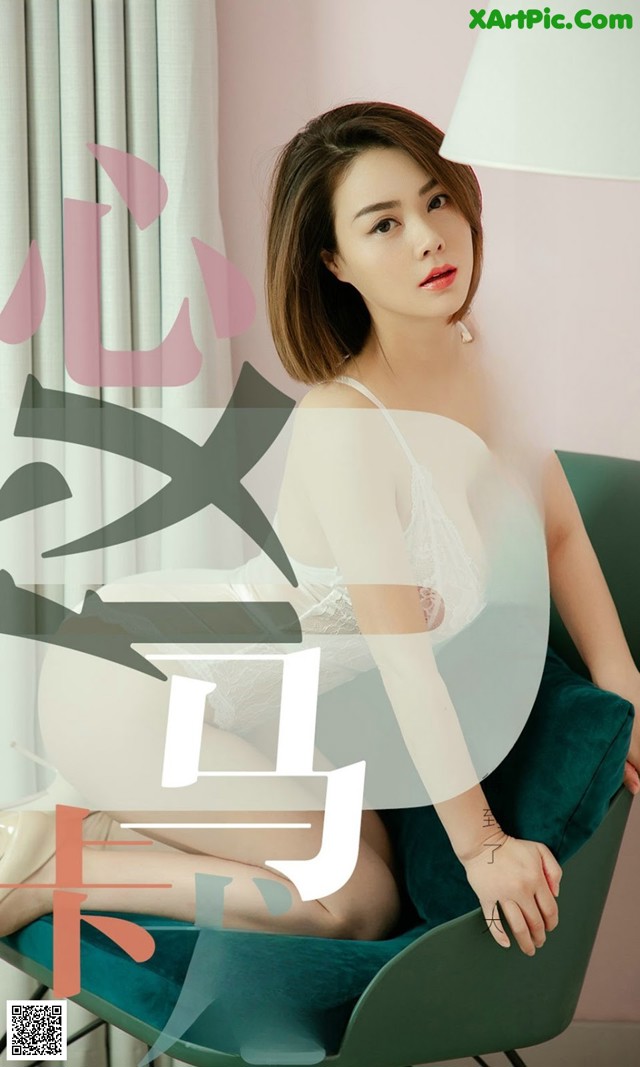 A woman sitting on top of a green chair.