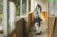 A woman in a school uniform standing in an abandoned building.