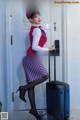 a woman in a red hat and skirt with a suitcase