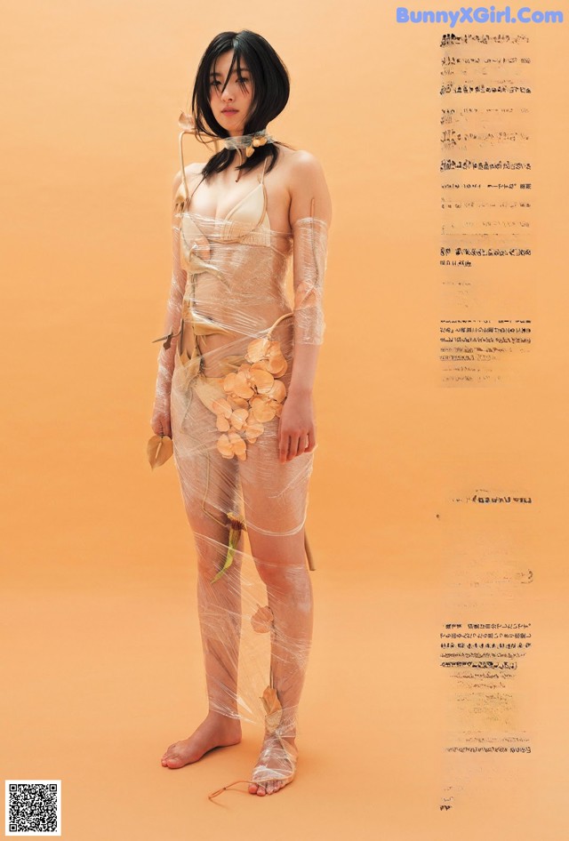 A woman in a sheer dress with flowers on it.
