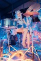 A woman sitting on top of a drum set.